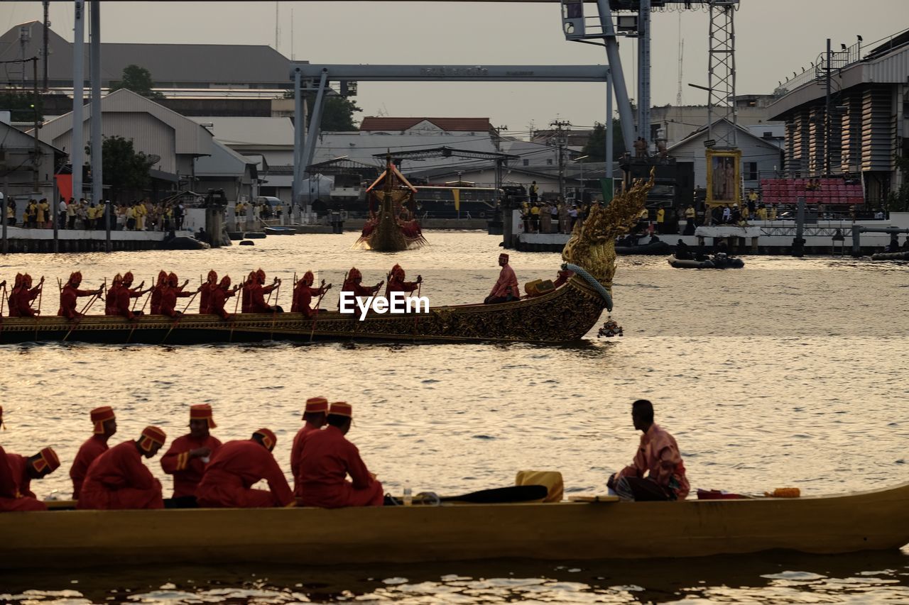 PEOPLE SITTING ON RIVERBANK