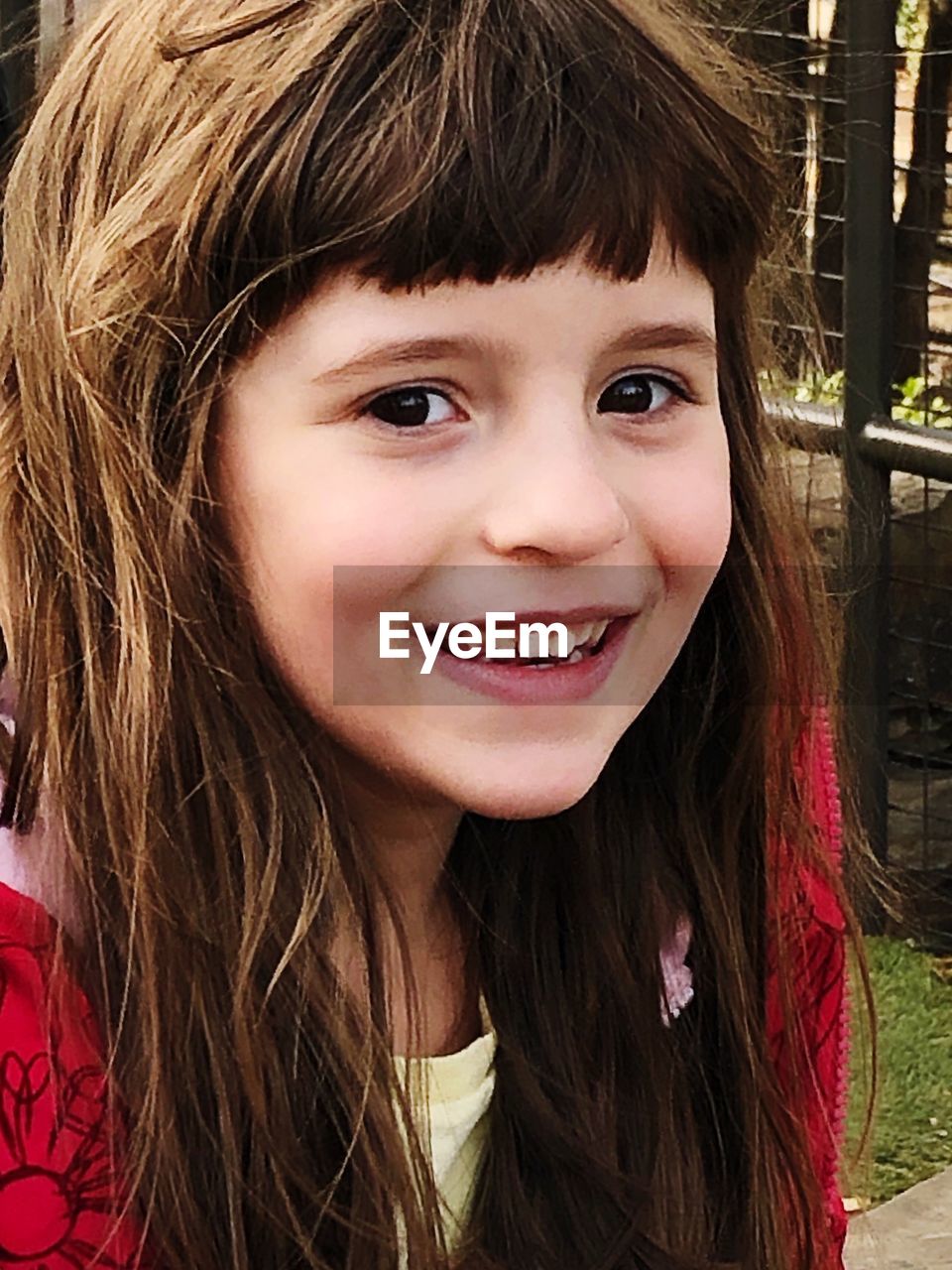 PORTRAIT OF A SMILING GIRL WITH HAIR