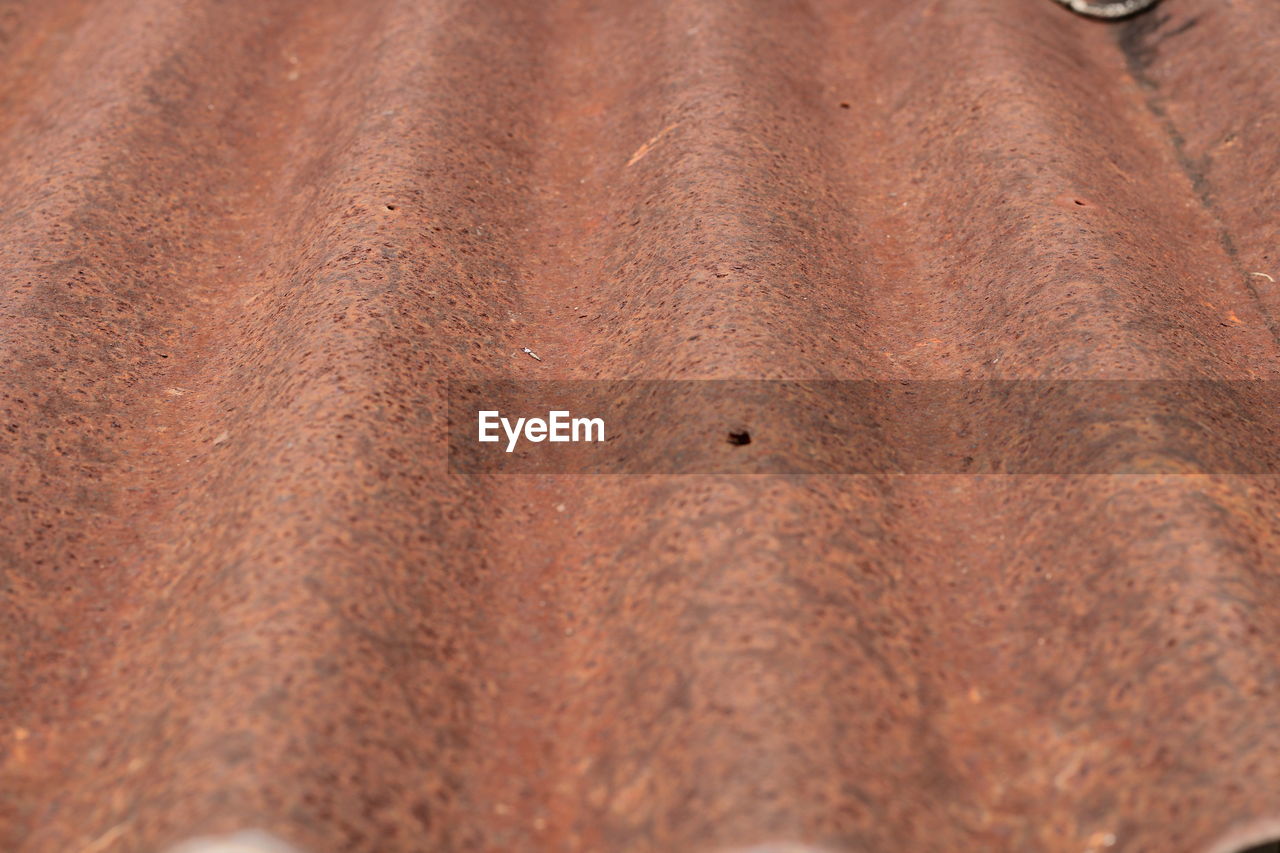 FULL FRAME SHOT OF RUSTY METAL WITH SAND