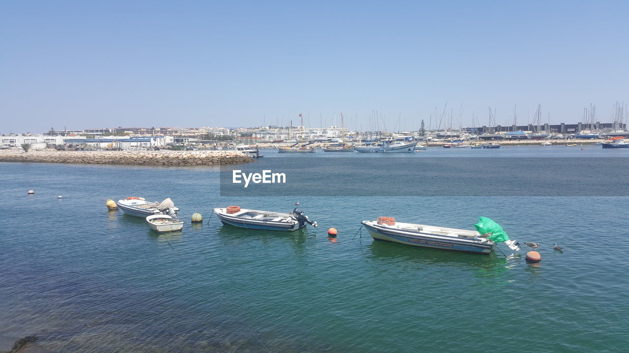 BOATS IN SEA AGAINST CLEAR SKY