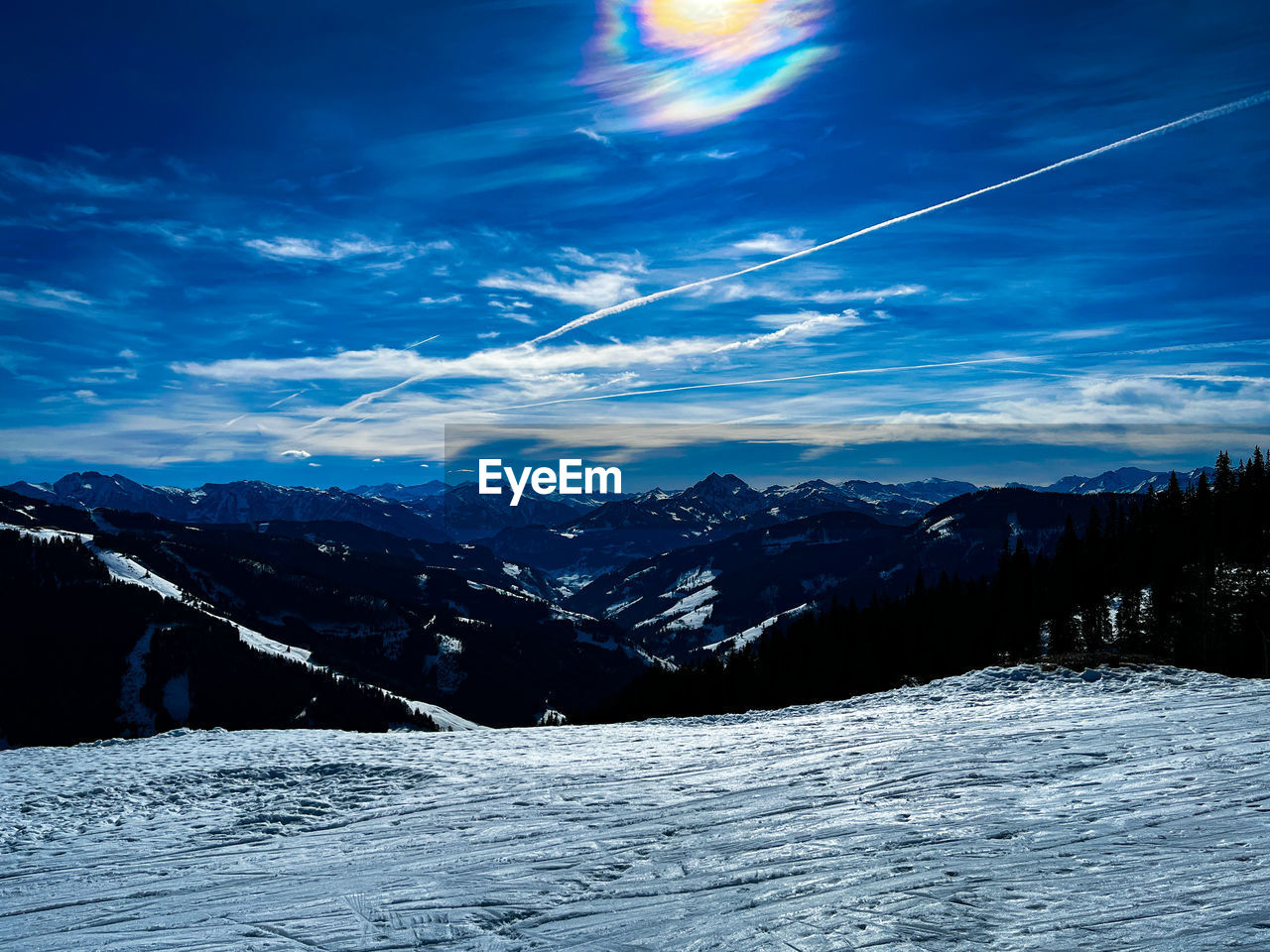 snow, sky, scenics - nature, cold temperature, winter, environment, mountain, beauty in nature, landscape, cloud, nature, mountain range, tranquil scene, tranquility, no people, blue, snowcapped mountain, land, non-urban scene, forest, idyllic, outdoors, sunlight, travel, tree, travel destinations, sun, frozen