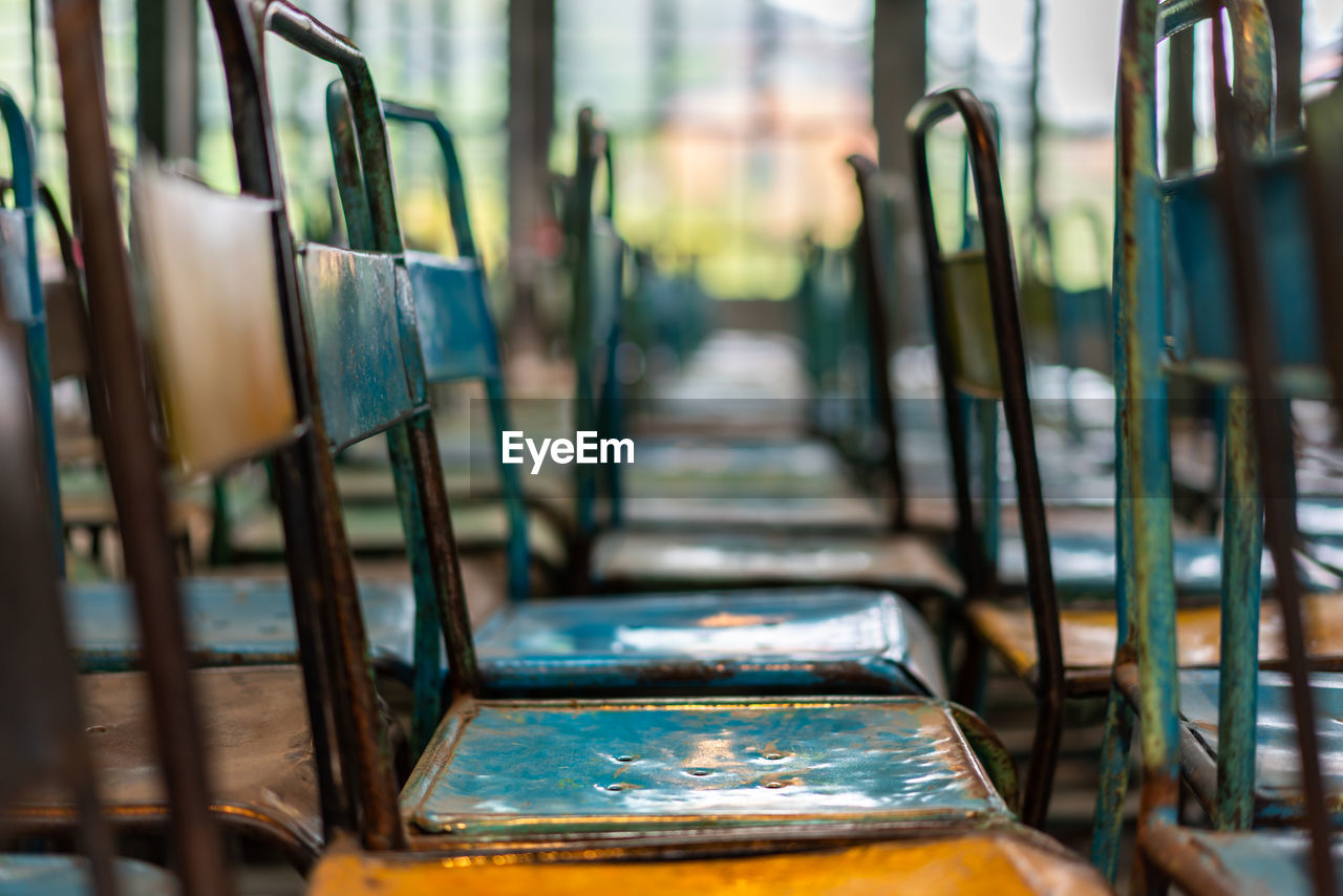 Empty metallic chairs in row at school