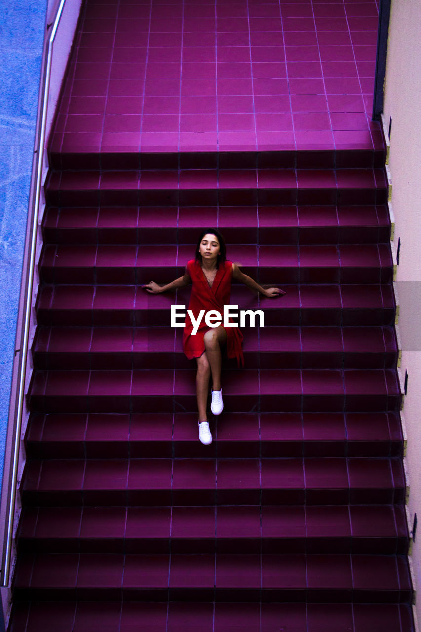High angle view of woman sitting on steps