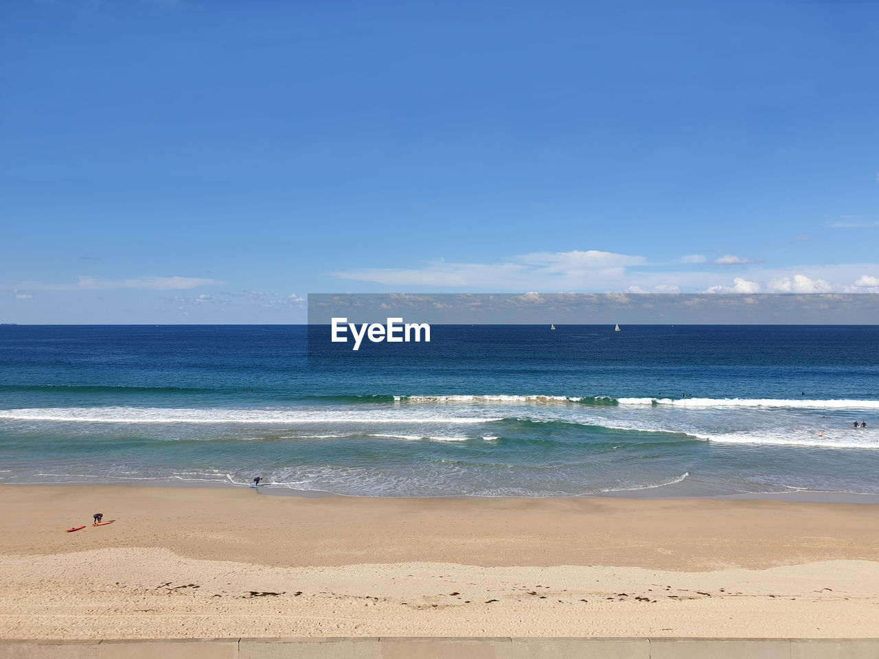 Scenic view of beach against blue sky