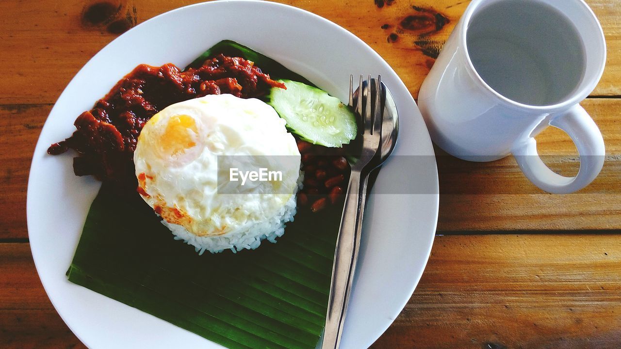 High angle view of food served in plate on wooden table