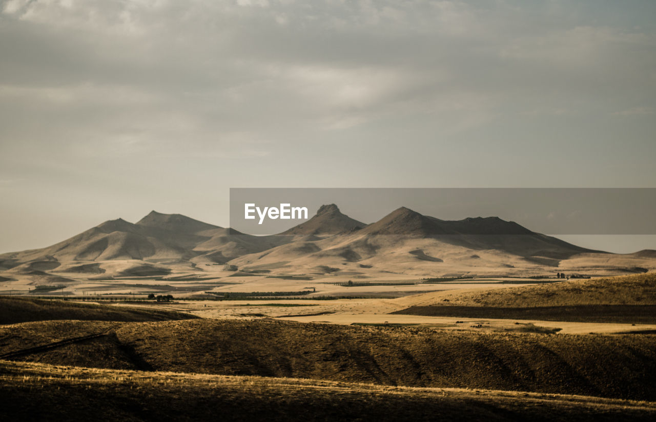 Scenic view of landscape and mountains against sky