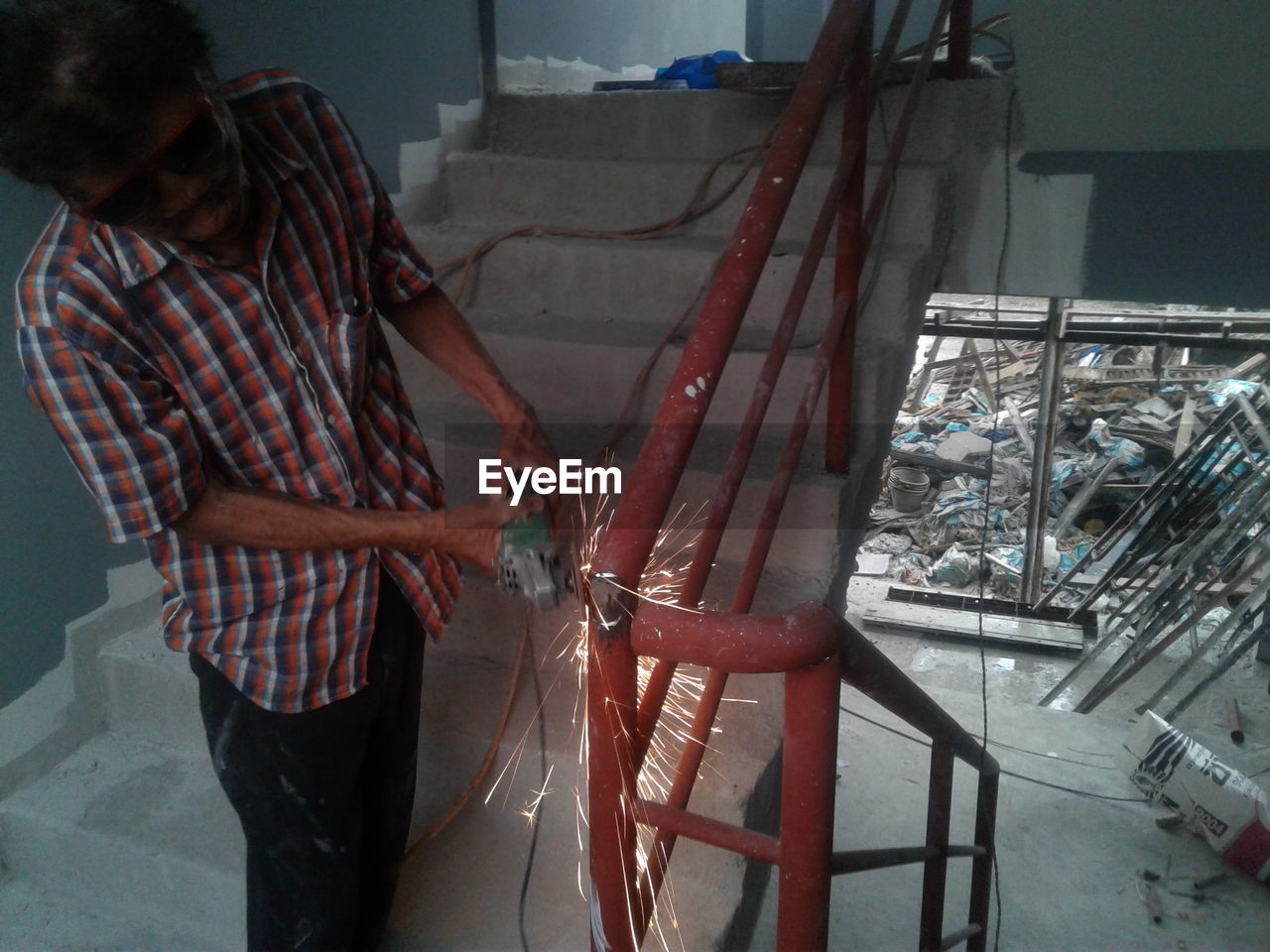 High angle view of man welding railing