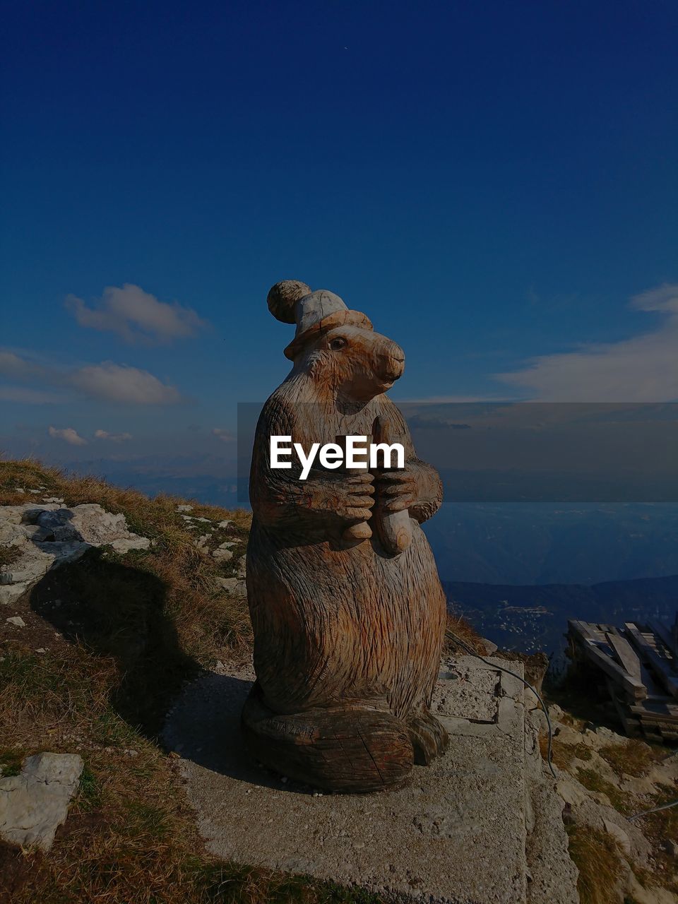 STATUE ON ROCK AGAINST SEA