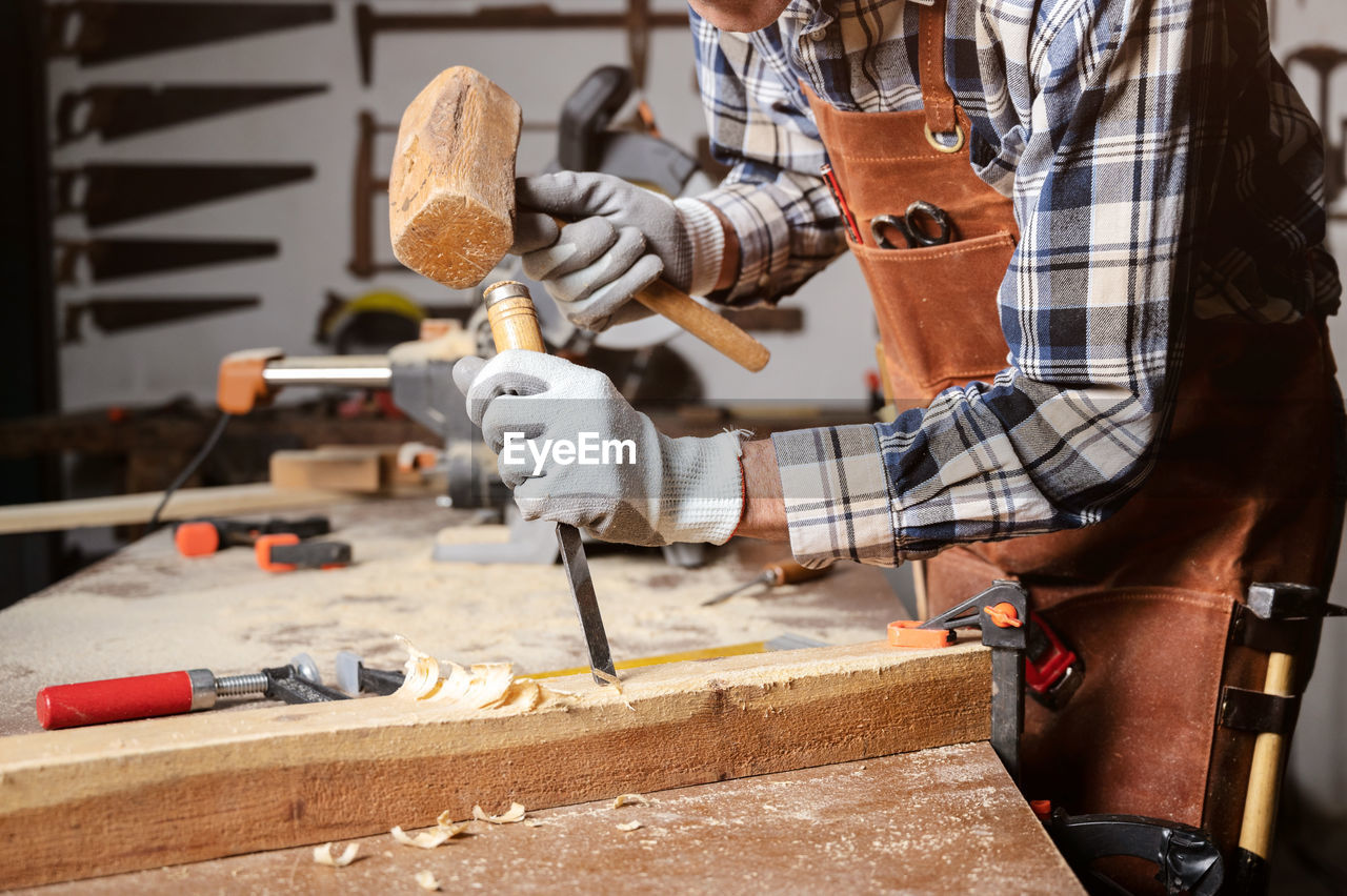 Midsection of man working in workshop