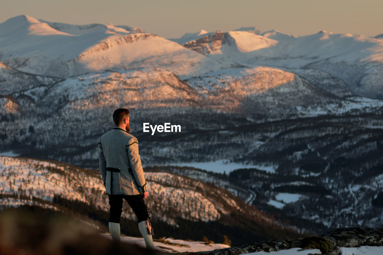 Rear view of man looking at mountains