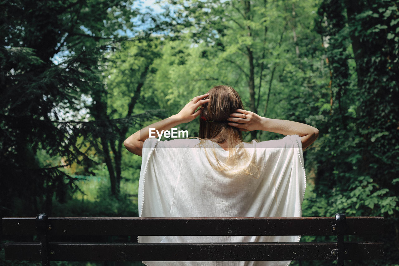 Rear view of woman against trees