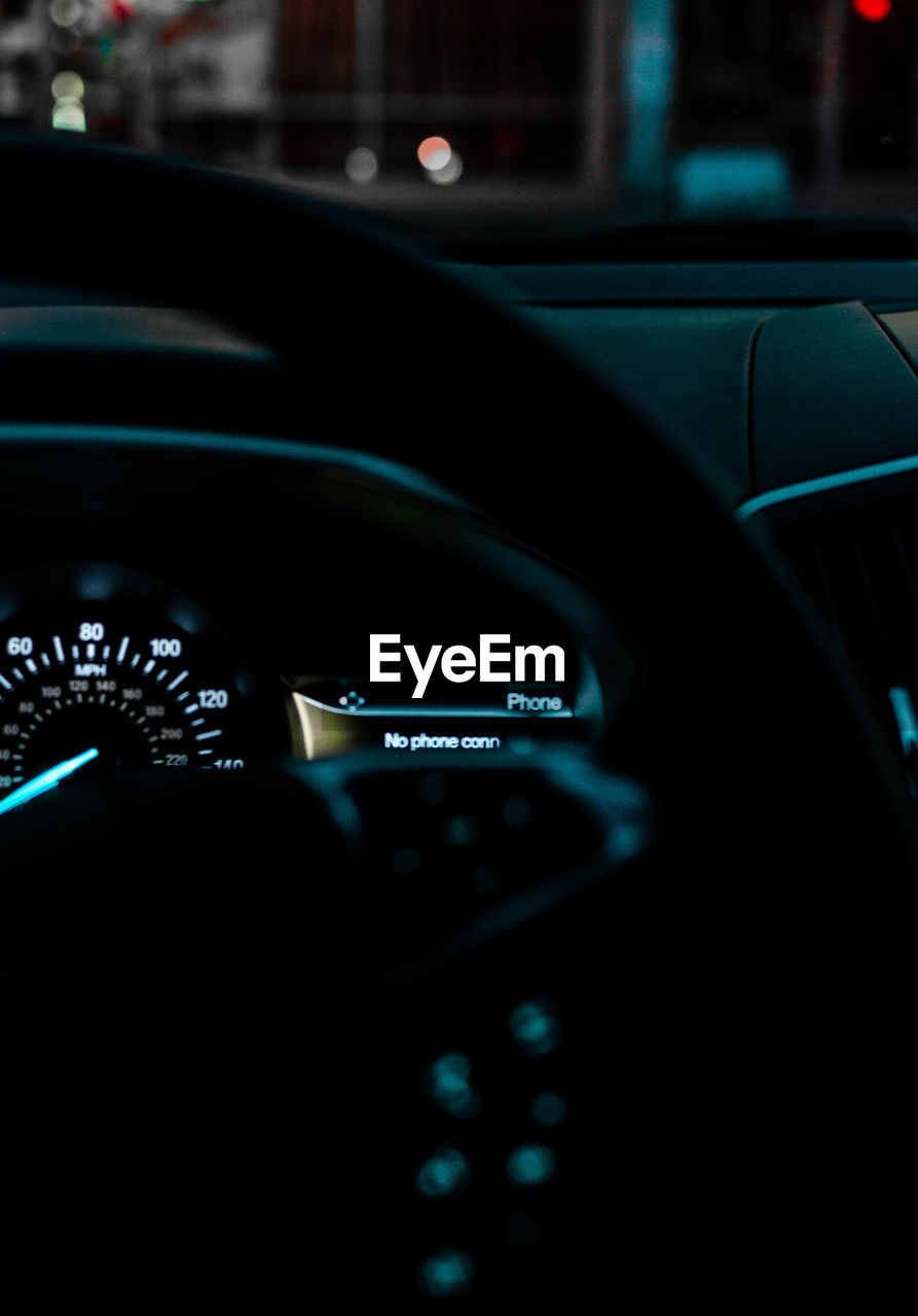 Close-up of speedometer in car at night