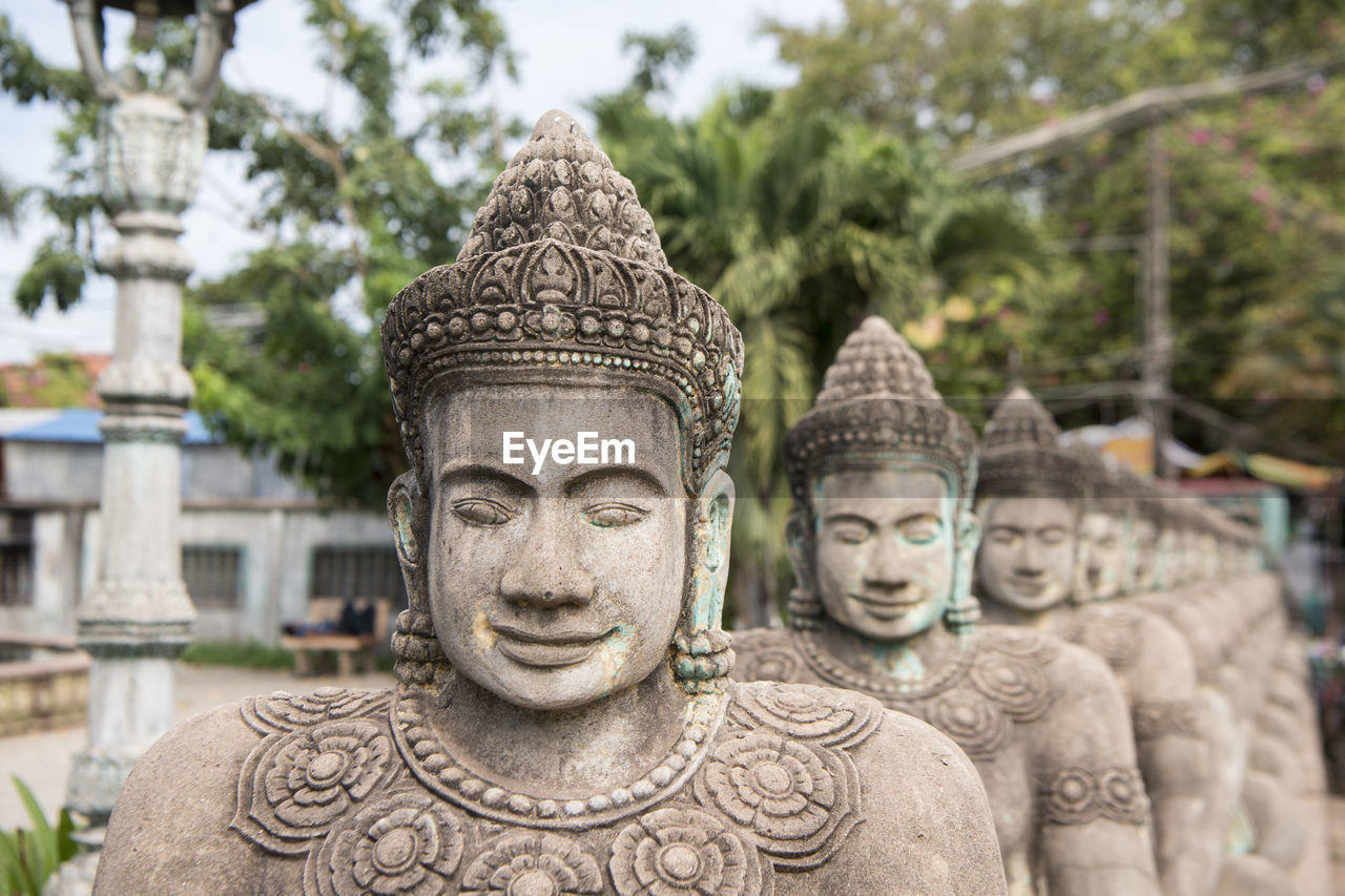 BUDDHA STATUE AGAINST TREES