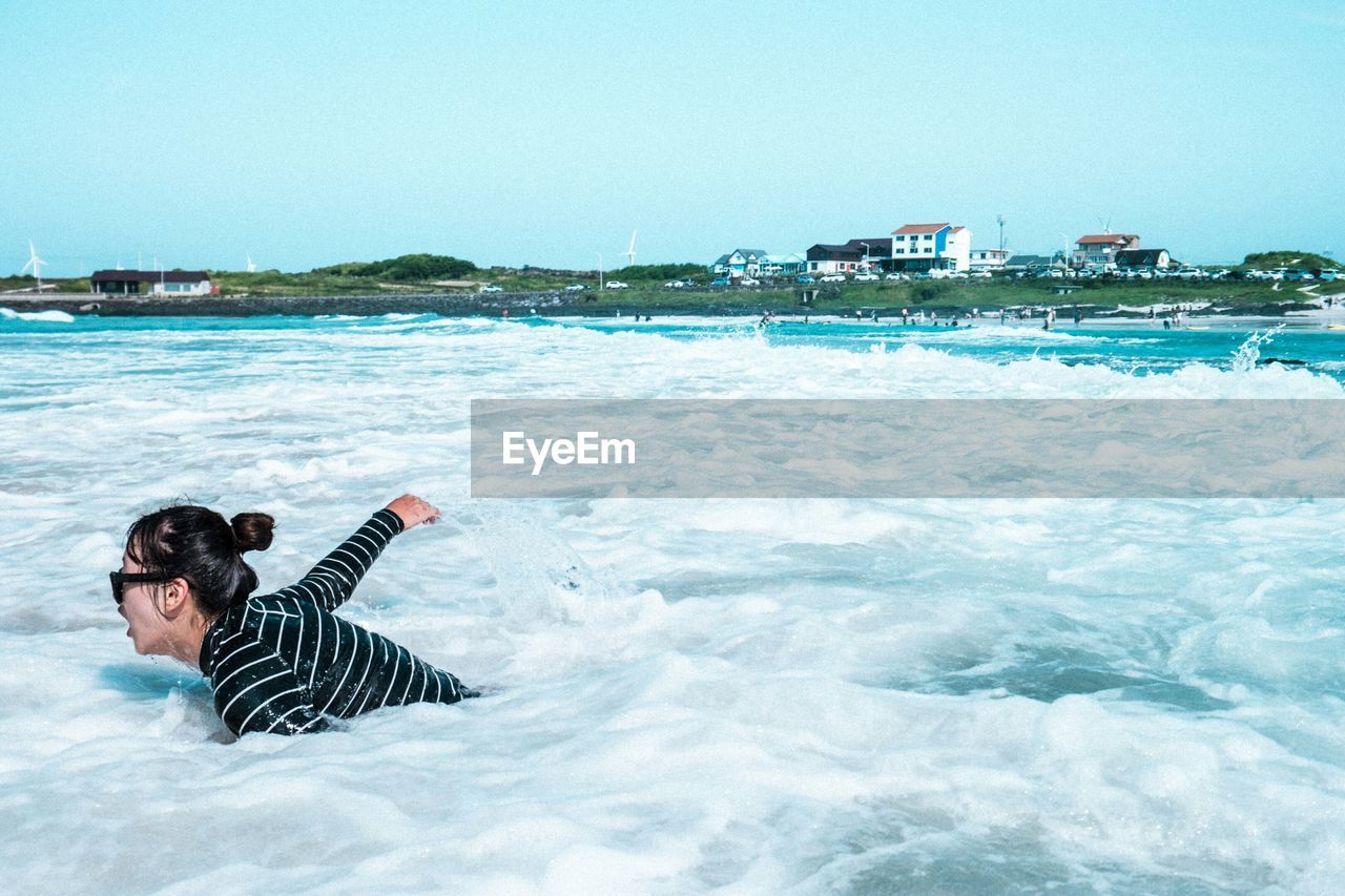 WOMAN JUMPING IN WATER