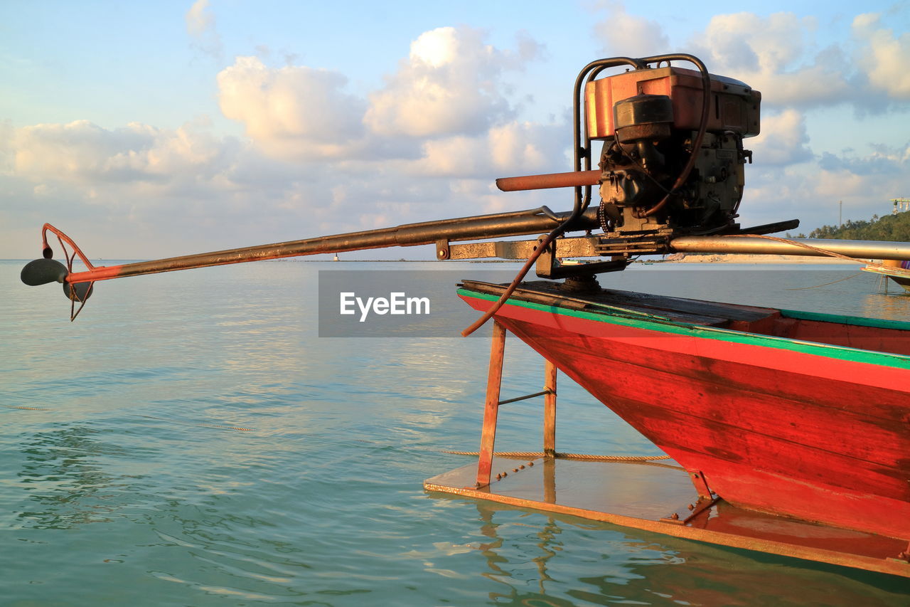 Cropped image of propeller boat moored on lake