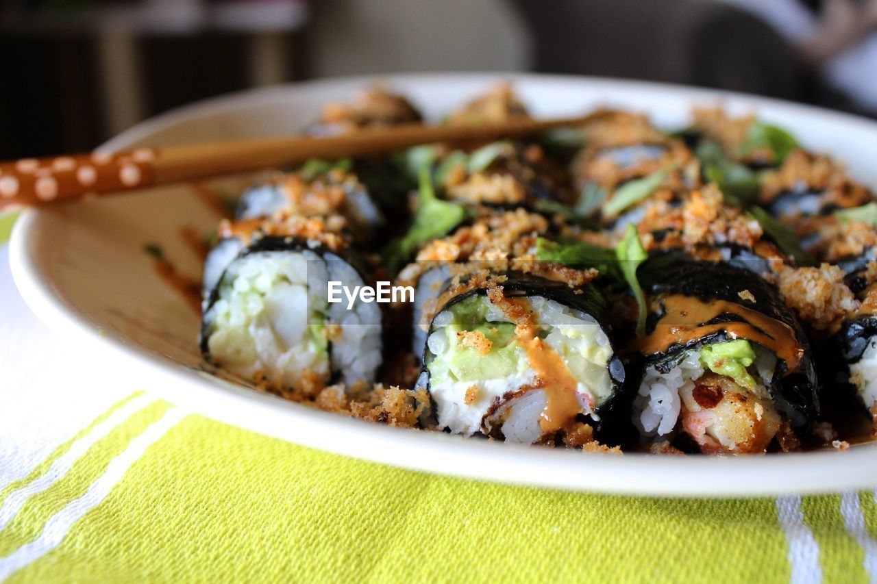 High angle view of sushi with chopsticks in plate