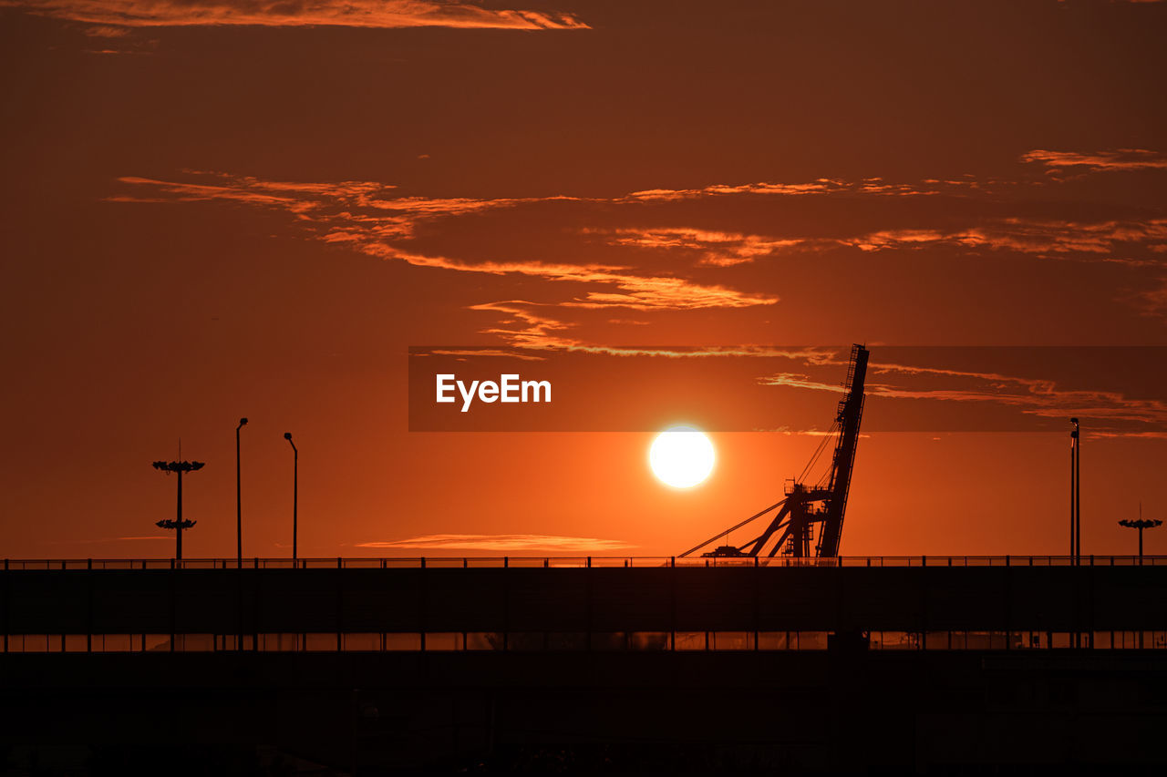 Silhouette bridge against sky during sunset