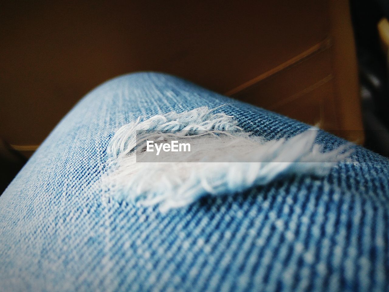 Cropped image of person wearing blue jeans