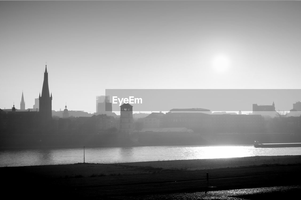 River in city against clear sky