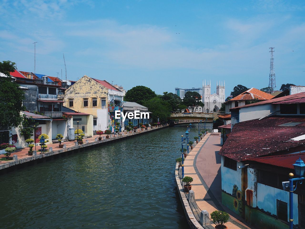 River amidst buildings in city against sky