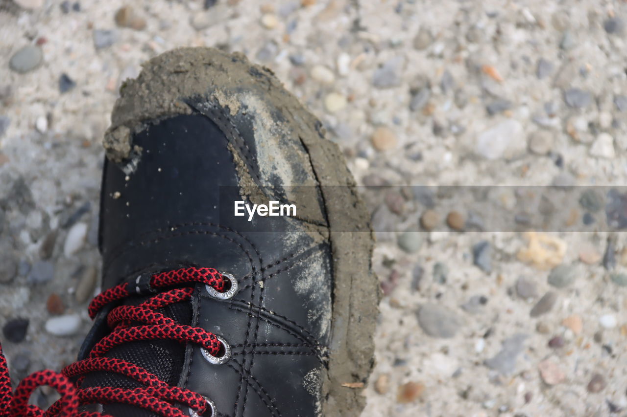 footwear, one person, shoe, nature, day, red, close-up, outdoors, focus on foreground, human leg, low section, rock, high angle view, land, leisure activity, lifestyles, personal perspective