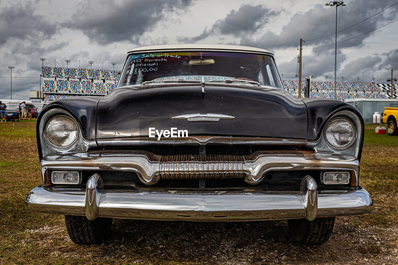 CLOSE-UP OF CAR AGAINST SKY