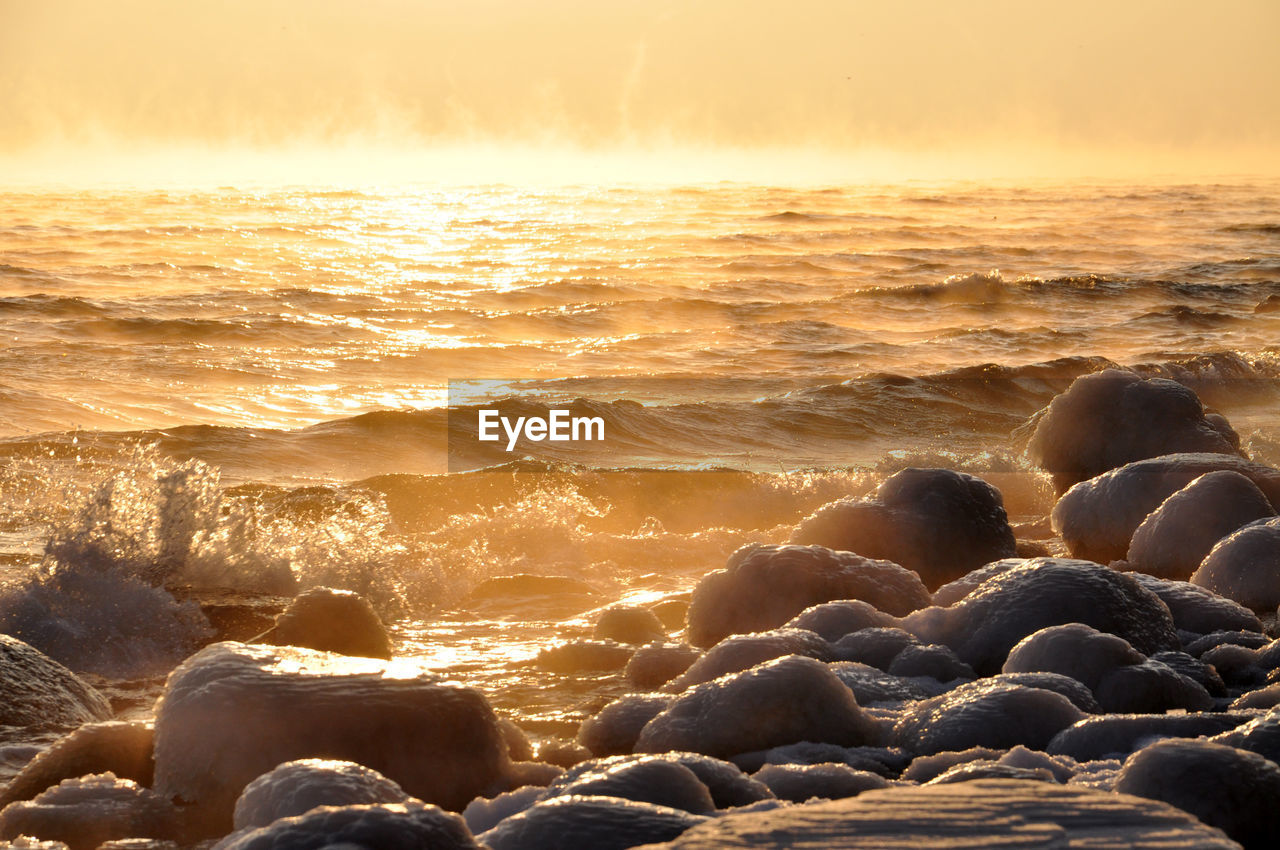 Scenic view of frozen rock formations in the baltic sea at sunset