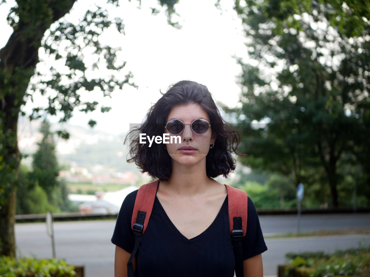 Portrait of young woman wearing sunglasses at park