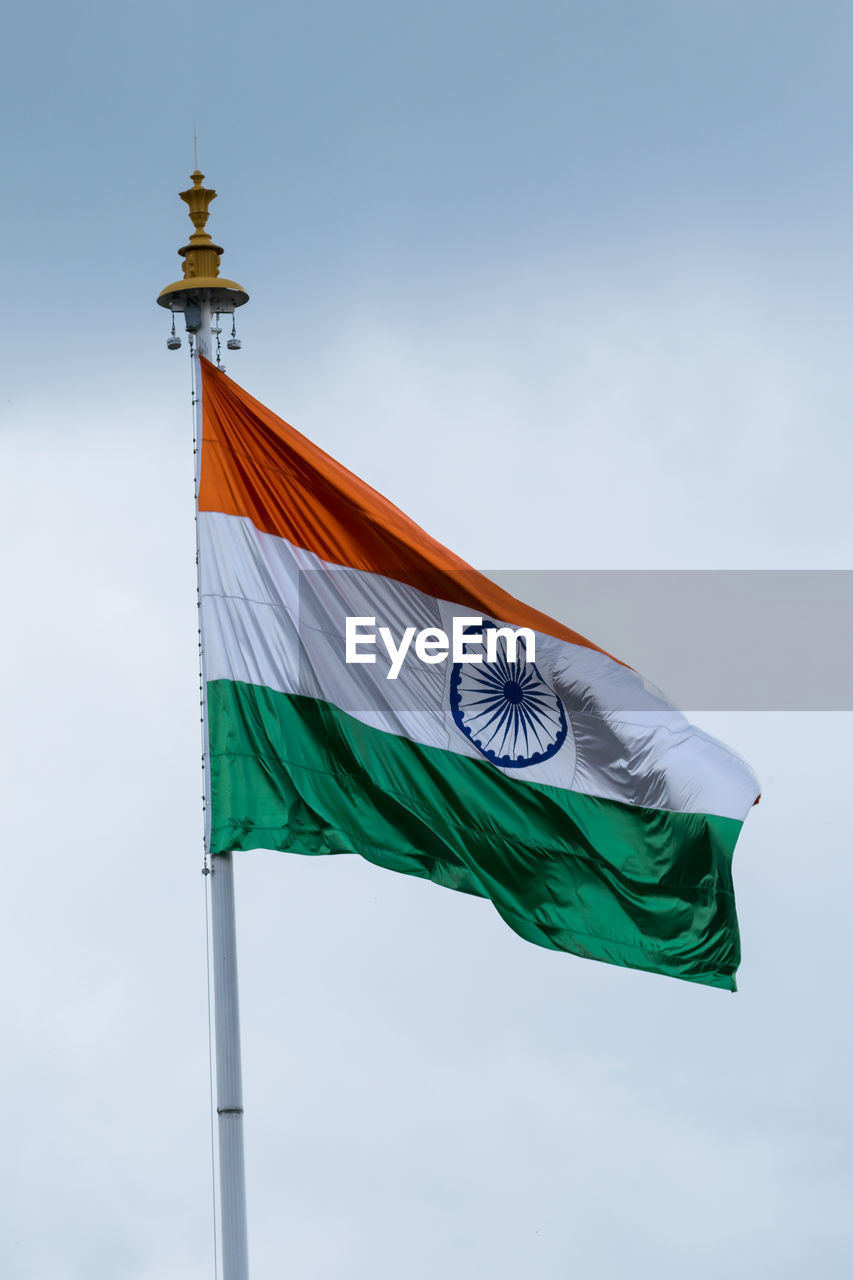 Low angle view of indian flag against sky