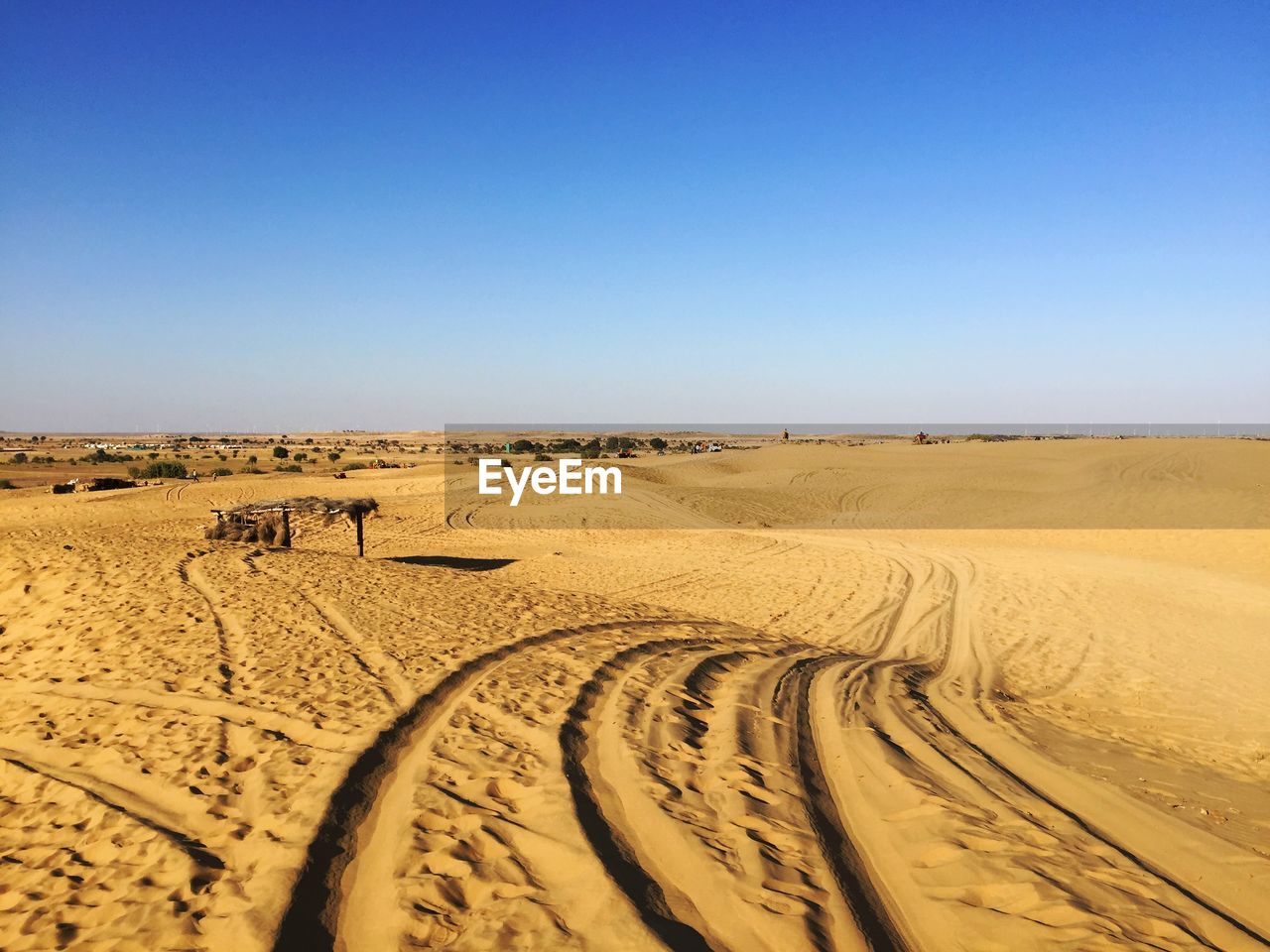 Scenic view of desert against clear blue sky