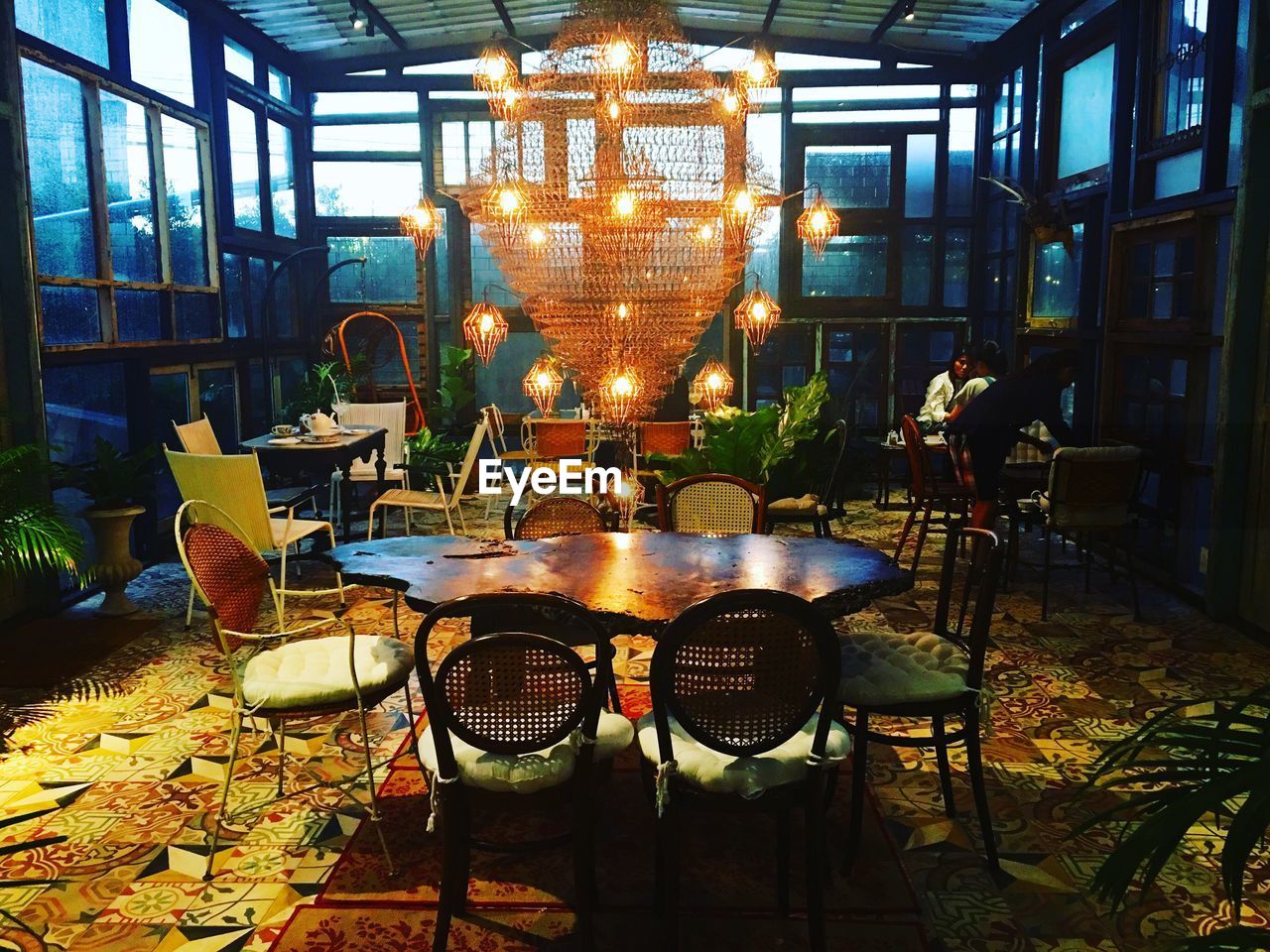 EMPTY CHAIRS AND TABLE AT RESTAURANT