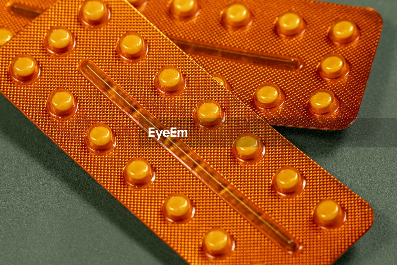 yellow, orange, no people, pill, dose, indoors, amber, close-up, healthcare and medicine, pattern, gold, medicine, studio shot, orange color
