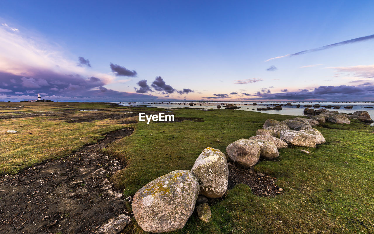 Rocks at sea shore against sky at oland