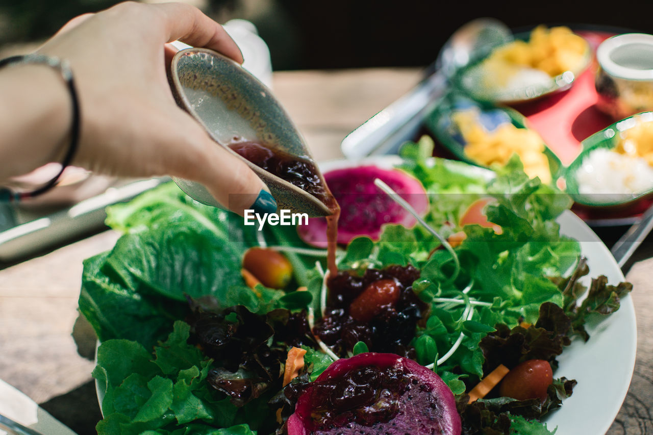 MIDSECTION OF PERSON HOLDING VEGETABLES