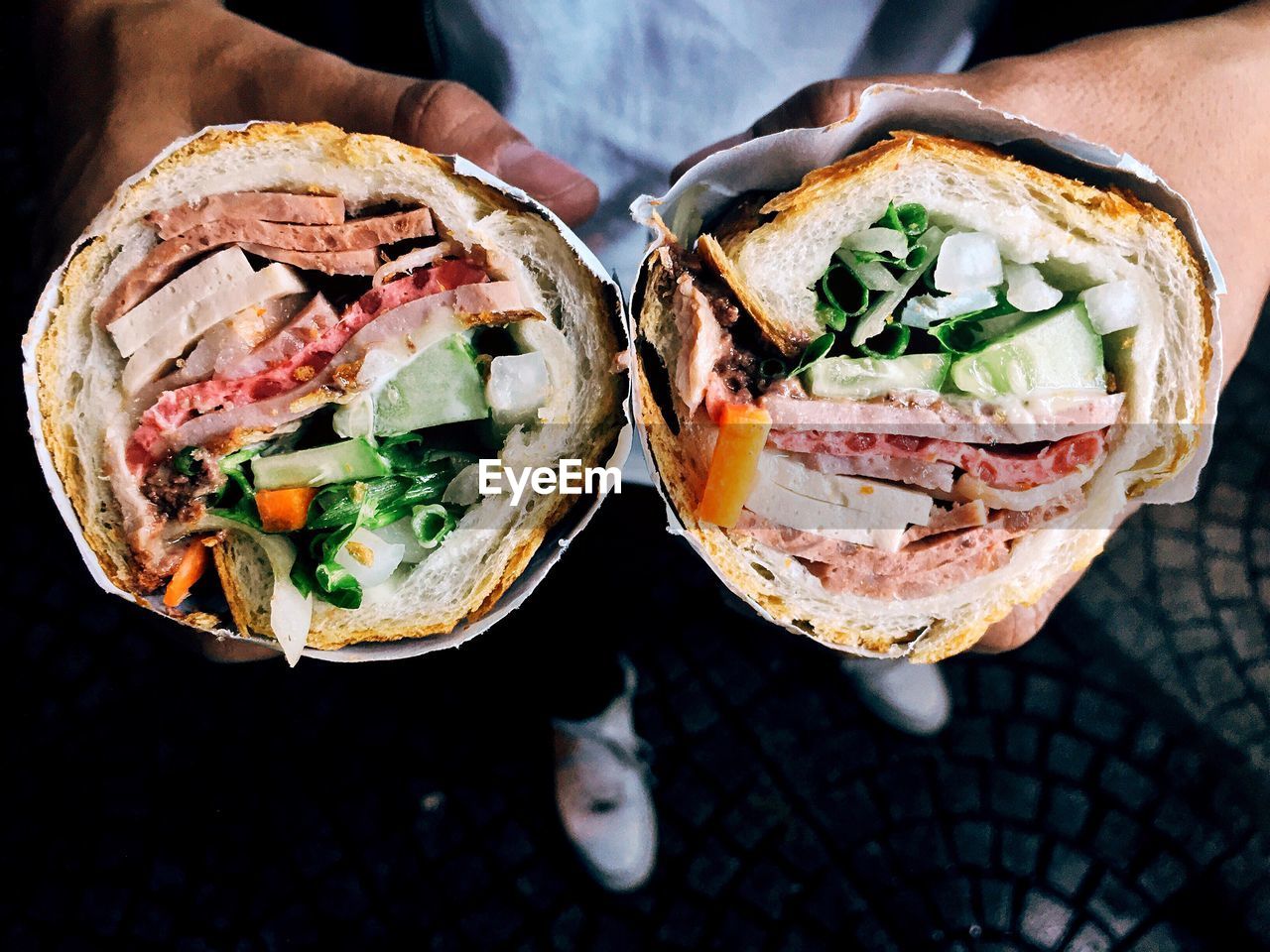 Cropped image of man holding meat wrap