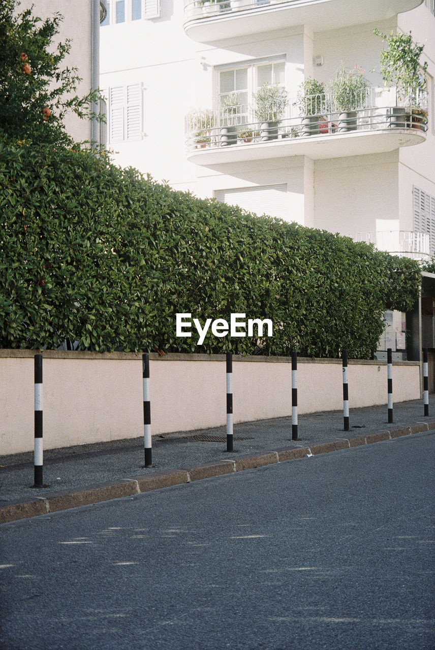 Empty footpath by buildings in city