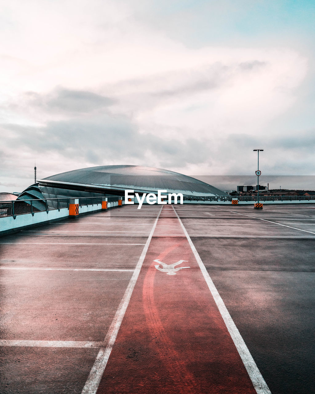 Surface level of airport runway against sky