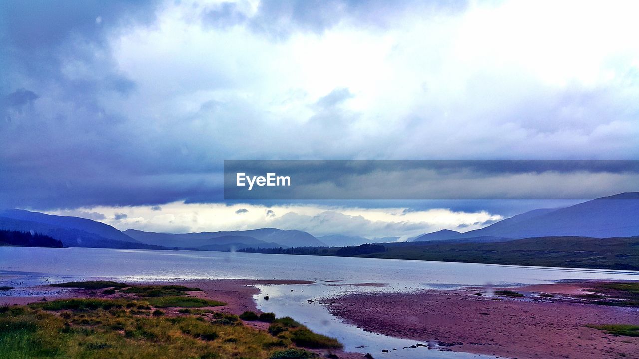 VIEW OF SEA AGAINST CLOUDY SKY