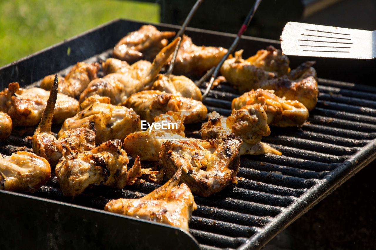 High angle view of chickens roasting on barbecue