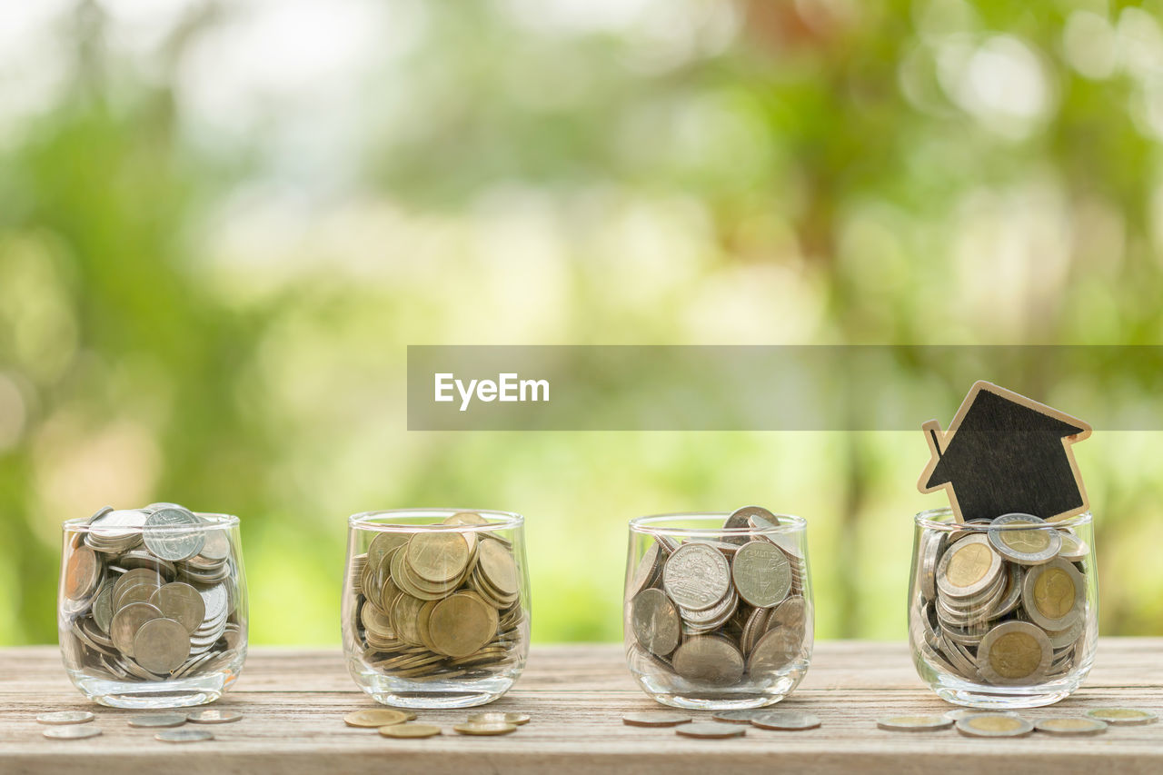 CLOSE-UP OF COINS ON GLASS TABLE