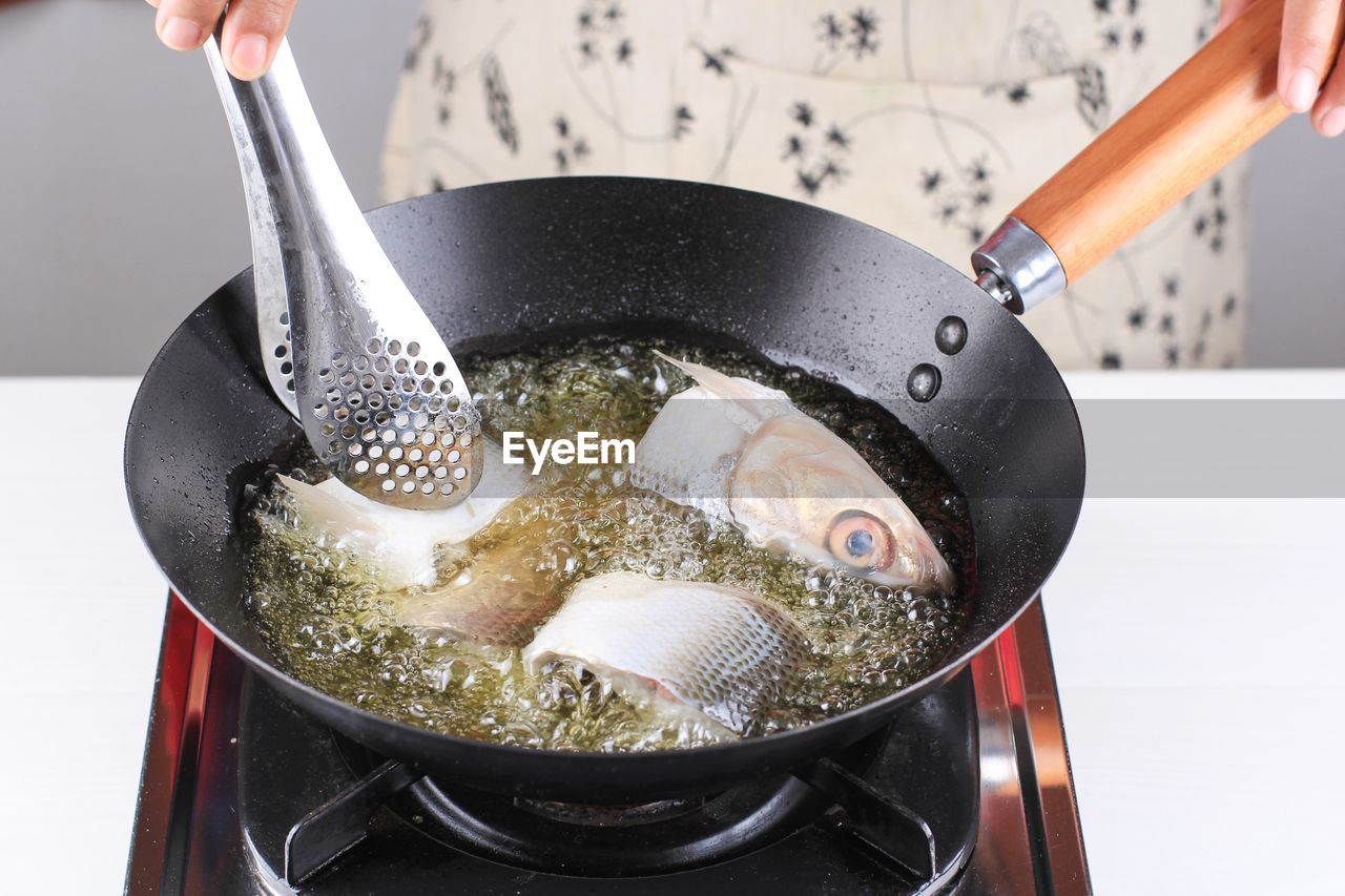 high angle view of man holding cooking in container