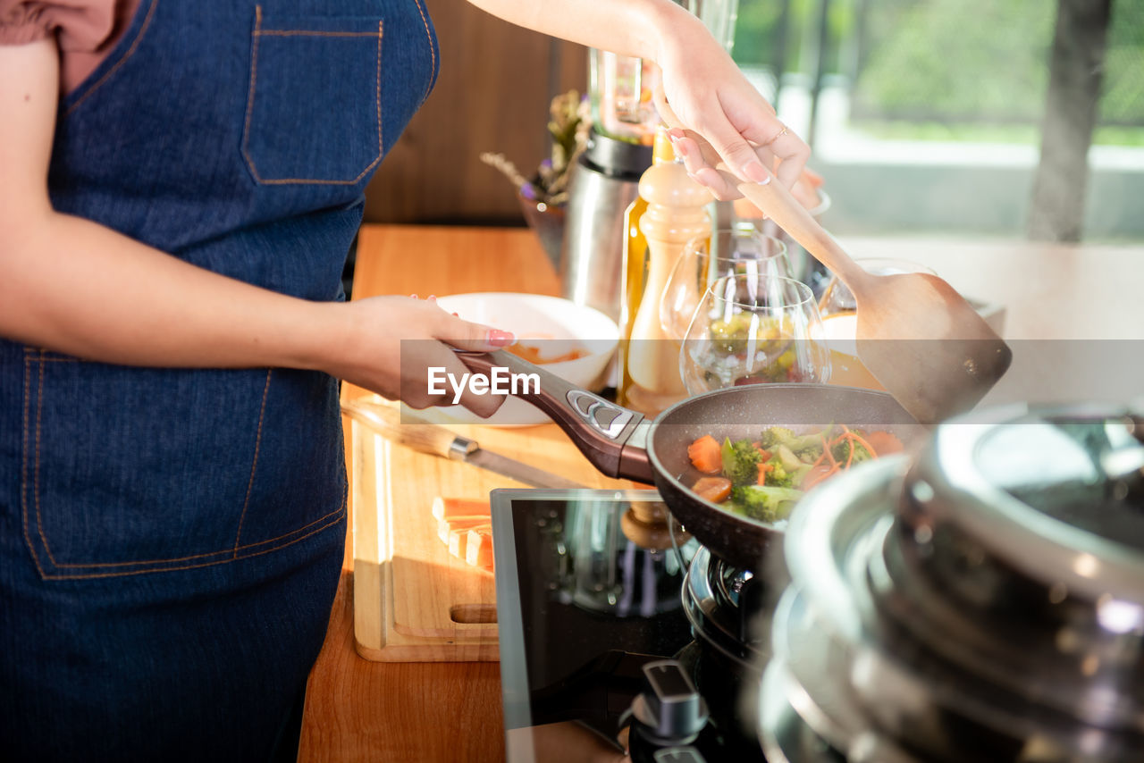 midsection of man preparing food