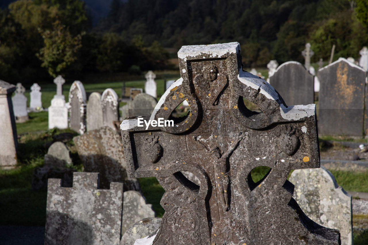 tombstone, cemetery, grave, stone, death, sadness, headstone, memorial, religion, cross, stone material, history, the past, spirituality, grief, no people, nature, tomb, belief, day, ancient history, emotion, architecture, mourning, tree, outdoors, plant, catholicism, war memorial, focus on foreground