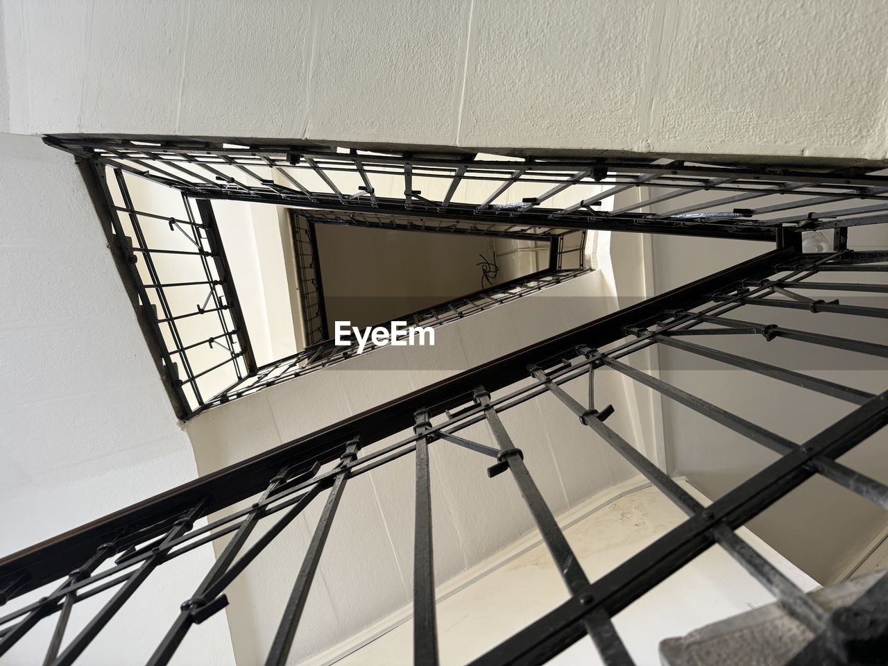 architecture, built structure, iron, low angle view, line, no people, daylighting, staircase, railing, building exterior, steps and staircases, metal, day, pattern, handrail, sky, white, outdoors, glass, spiral, spiral staircase