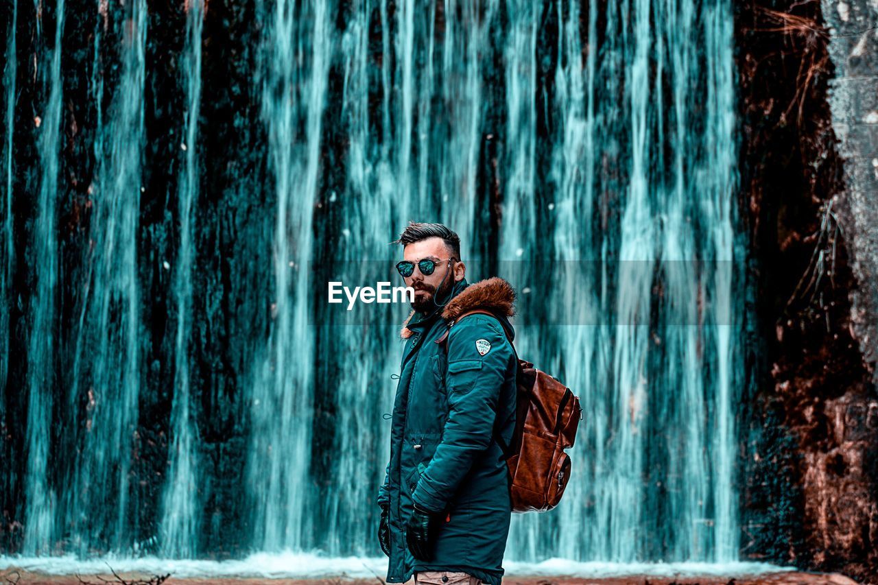 Man looking at waterfall