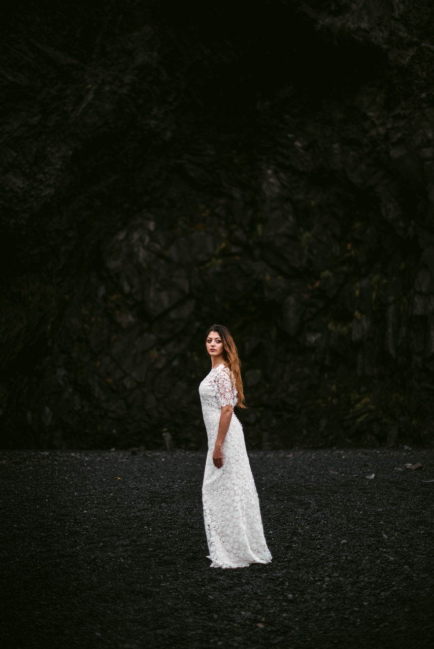 WOMAN STANDING ON ROCK