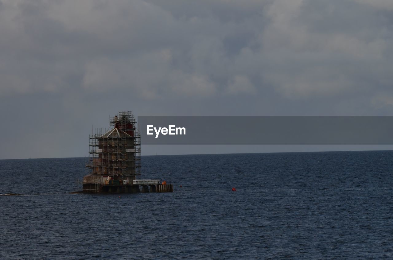 water, sky, sea, cloud, horizon over water, horizon, ocean, nature, coast, scenics - nature, offshore platform, vehicle, beauty in nature, no people, built structure, waterfront, outdoors, industry, day, oil industry, power generation, tranquility, architecture, bay, drilling rig, tranquil scene, shore, tower, oil rig