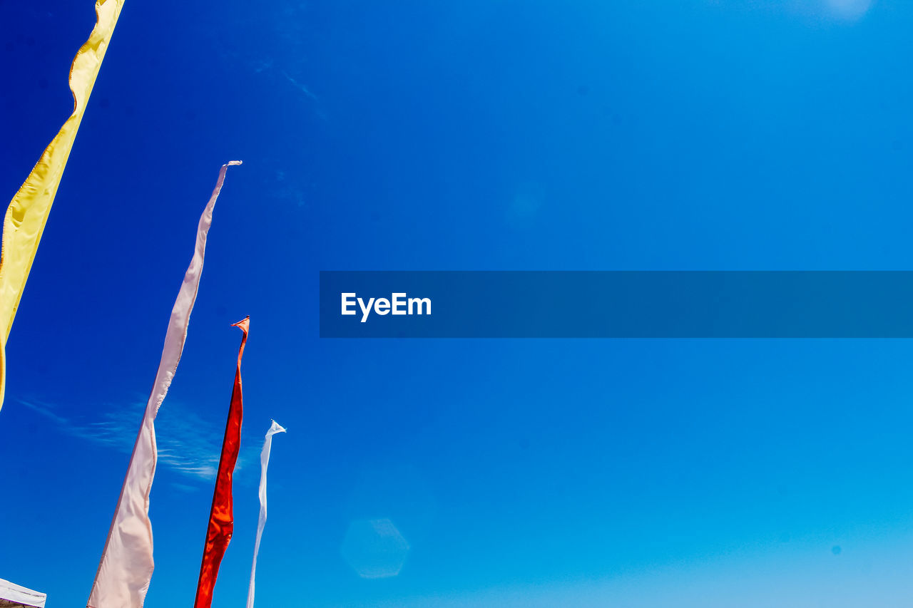 Low angle view of tree against clear blue sky