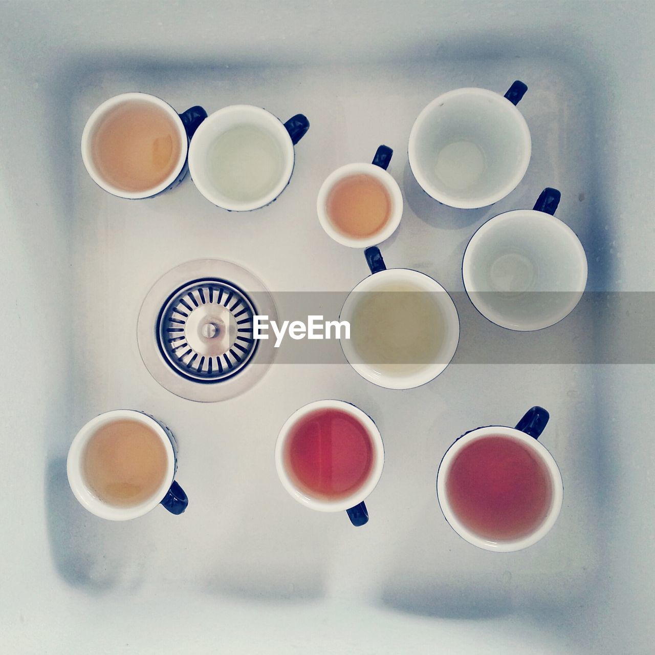 High angle view of mugs in kitchen sink