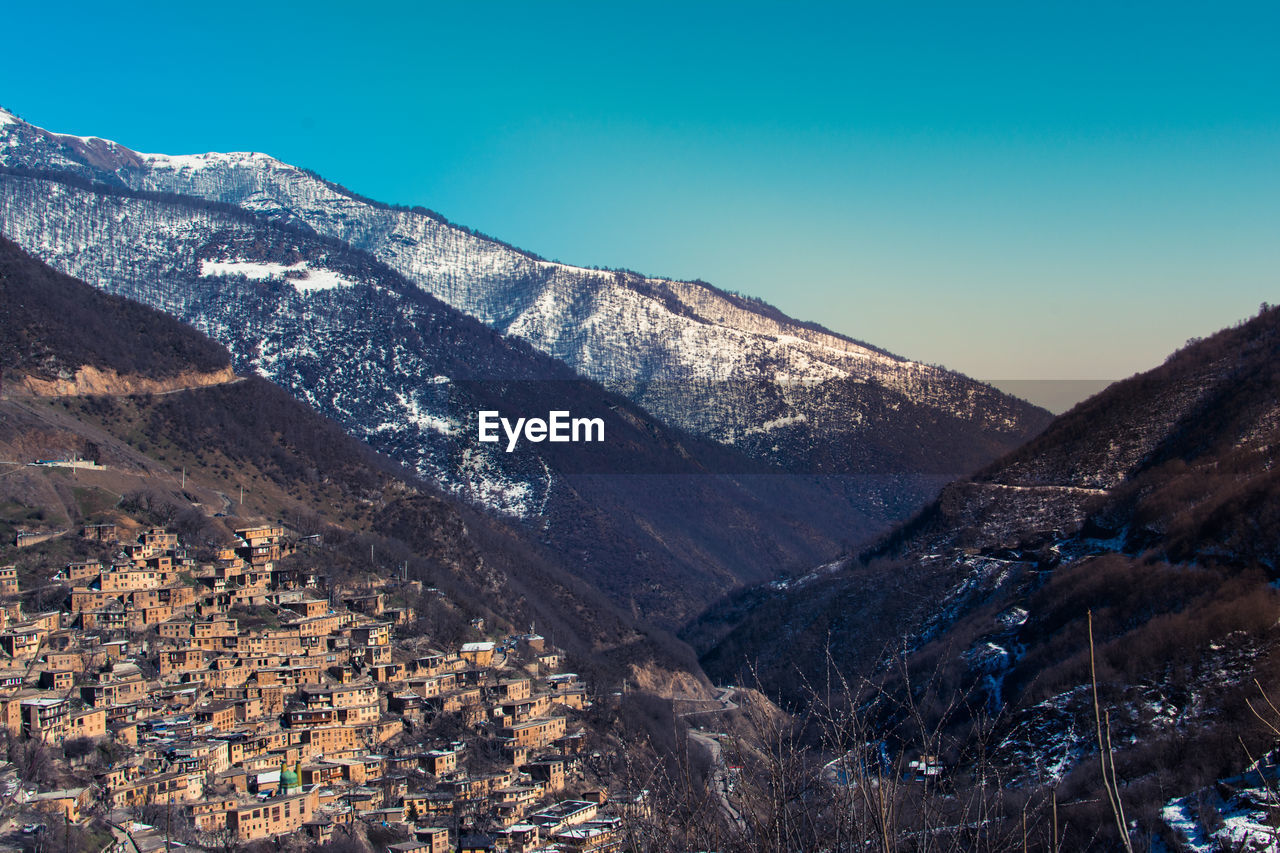 High angle view of snowcapped mountains against clear sky